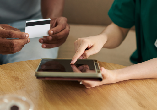 social-worker-helping-patient-with-tablet-and-card-2026-03-18-14-53-48-utc 1